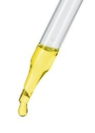 Photo of Dripping essential oil from pipette on white background