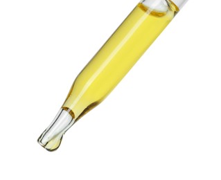 Photo of Dripping essential oil from pipette on white background