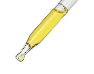 Dripping essential oil from pipette on white background