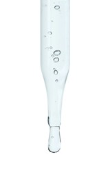 Photo of Dripping cosmetic serum from pipette on white background