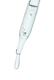 Photo of Dripping cosmetic serum from pipette on white background