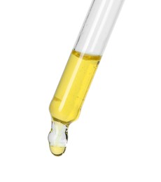 Photo of Dripping essential oil from pipette on white background