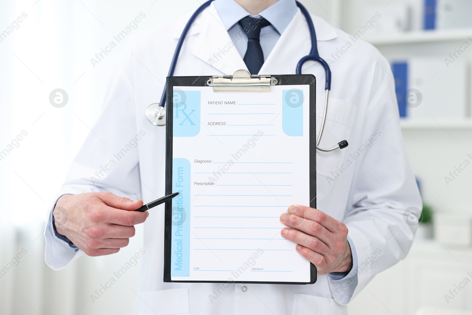 Photo of Doctor with blank prescription form in clinic, closeup