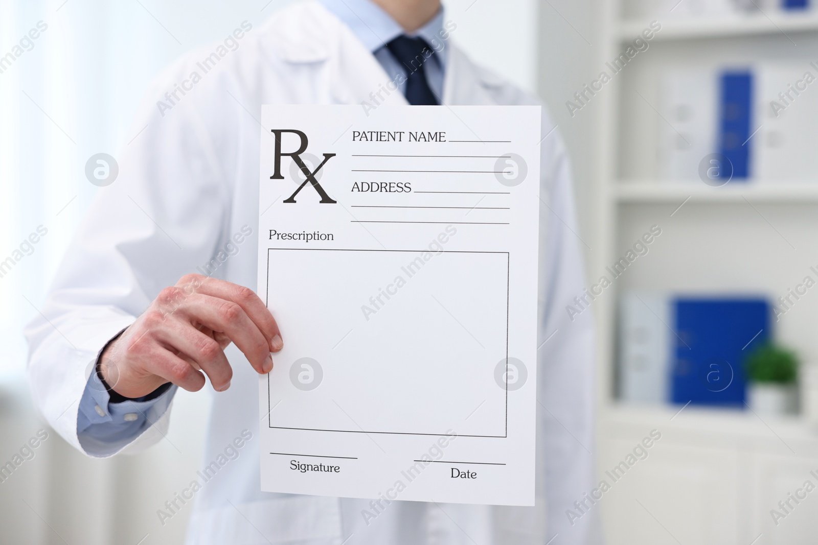 Photo of Doctor with blank prescription form in clinic, closeup