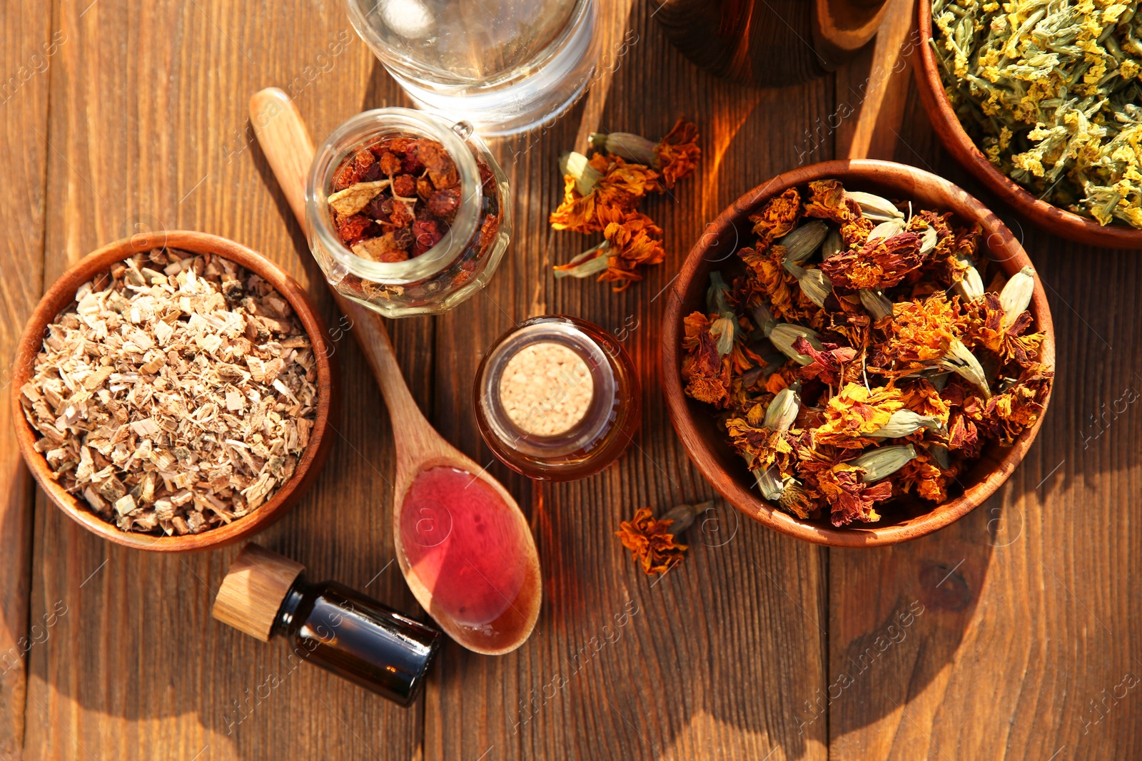 Photo of Different tinctures and ingredients on wooden table, flat lay