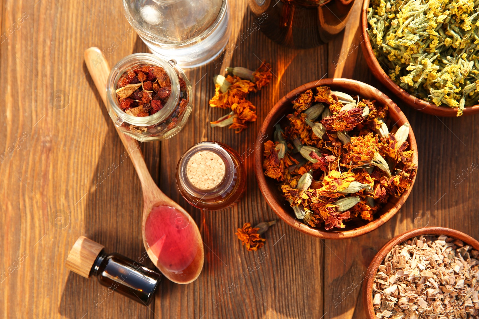 Photo of Different tinctures and ingredients on wooden table, flat lay