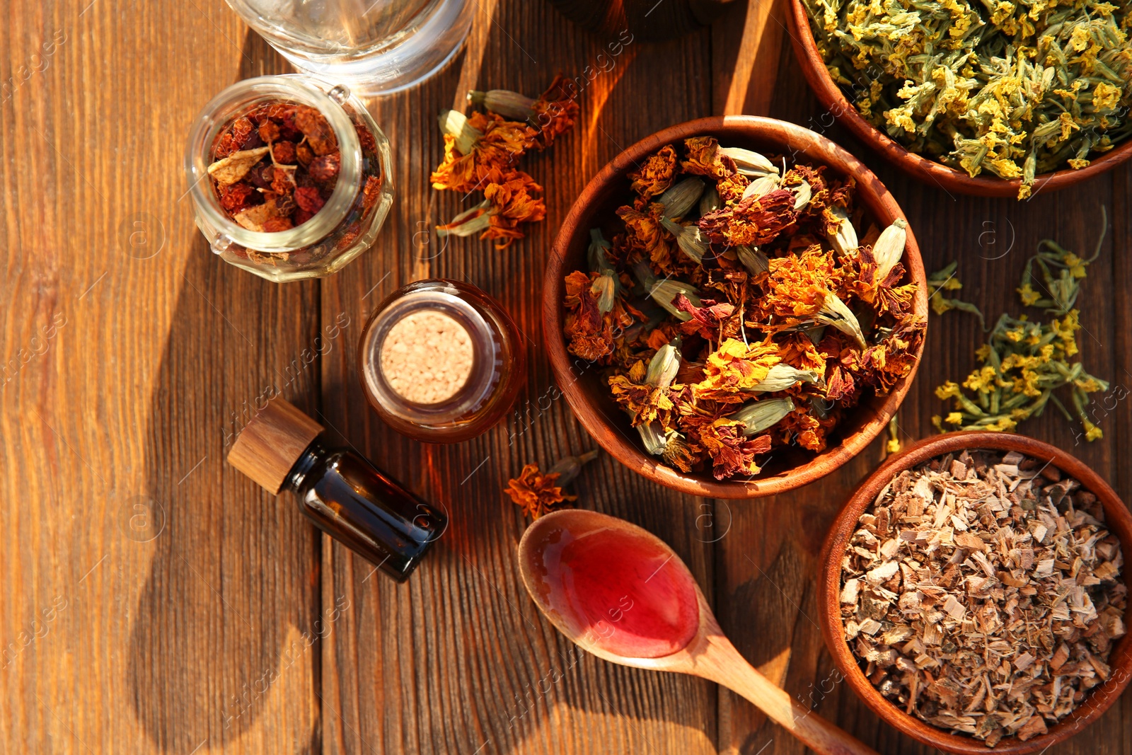 Photo of Different tinctures and ingredients on wooden table, flat lay