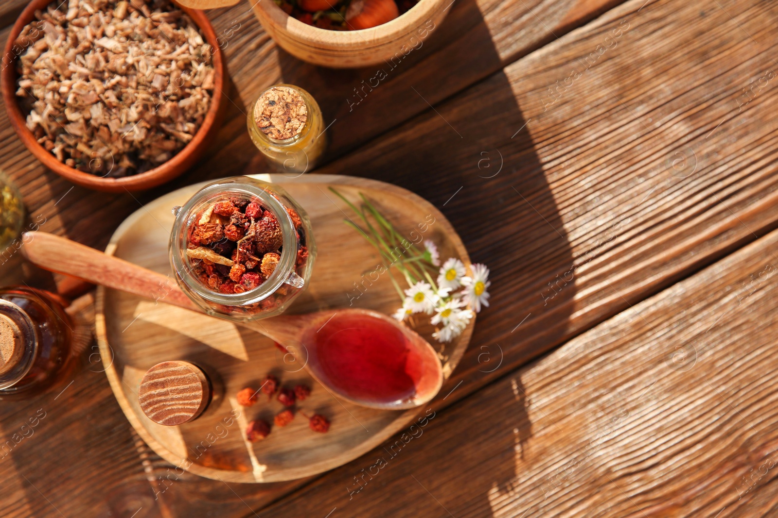 Photo of Tincture and different ingredients on wooden table, top view. Space for text