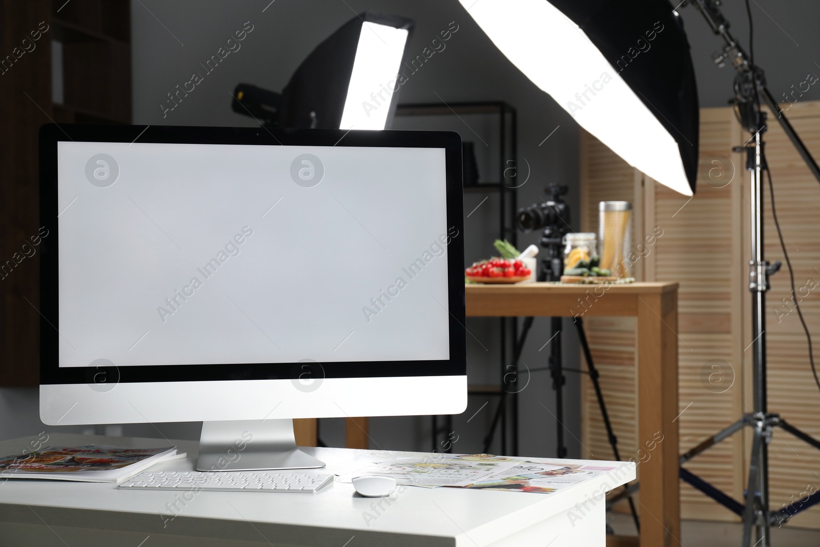 Photo of Shooting food in photo studio with professional lighting equipment, focus on computer