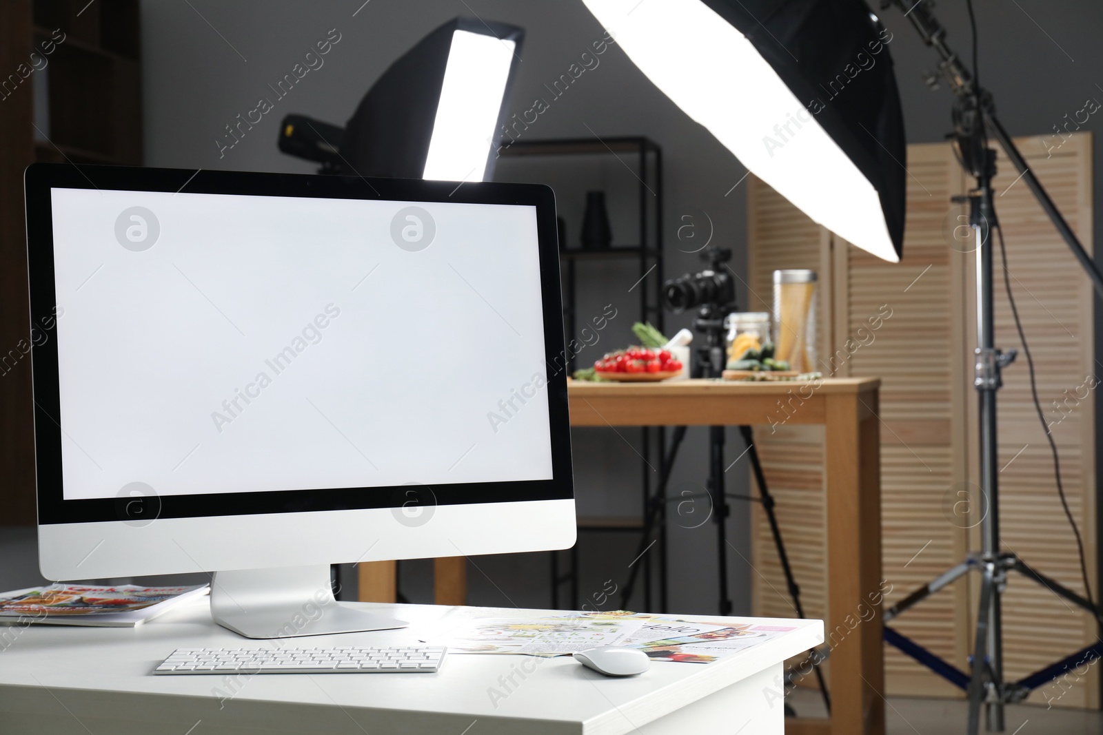 Photo of Shooting food in photo studio with professional lighting equipment, focus on computer