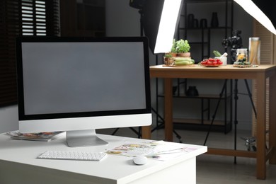 Shooting food in photo studio with professional lighting equipment, focus on computer