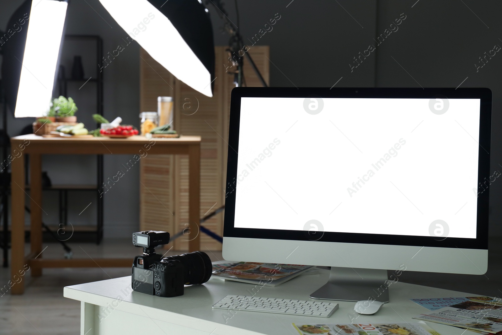 Photo of Shooting food in photo studio with professional lighting equipment, focus on computer