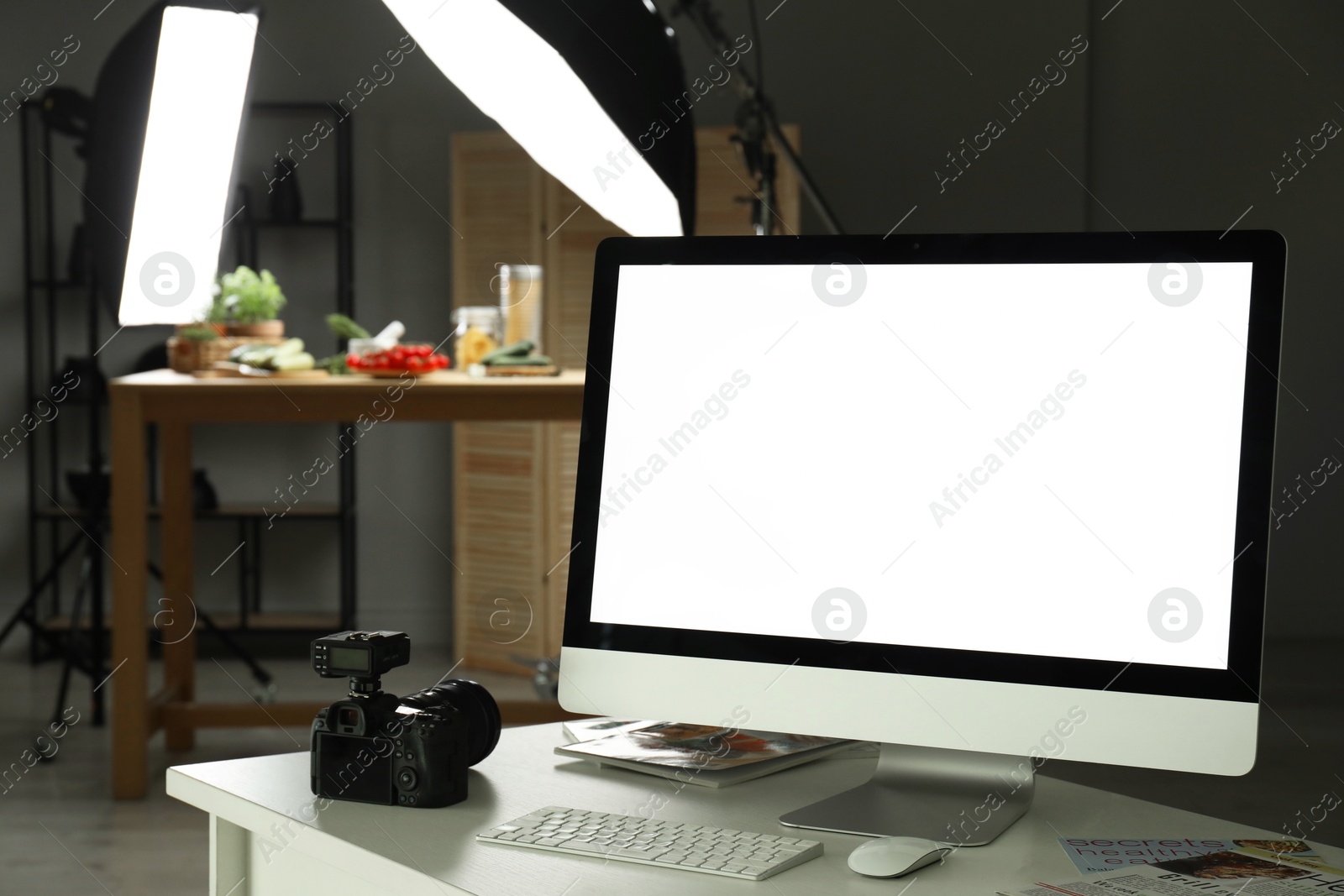 Photo of Shooting food in photo studio with professional lighting equipment, focus on computer