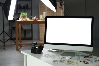 Photo of Shooting food in photo studio with professional lighting equipment, focus on computer