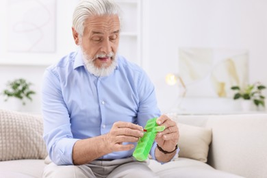 Photo of Senior man with pill and organizer at home