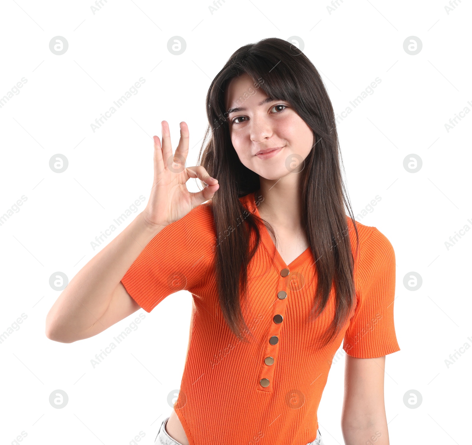 Photo of Portrait of cute teenage girl showing ok gesture on white background