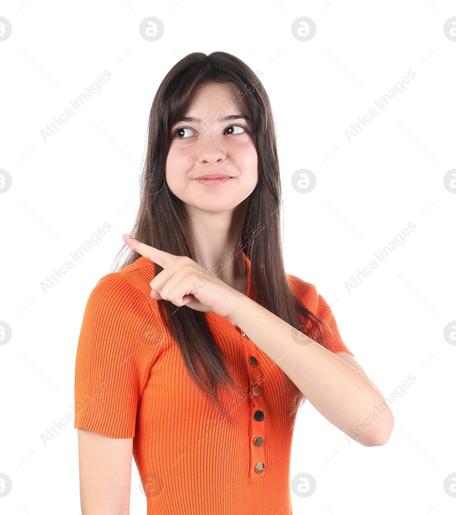 Photo of Portrait of cute teenage girl pointing at something on white background