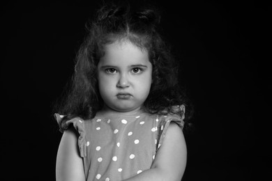 Photo of Portrait of sad girl on dark background. Black and white effect