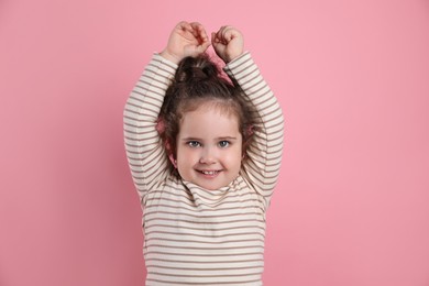 Photo of Adorable child. Portrait of happy girl on pink background