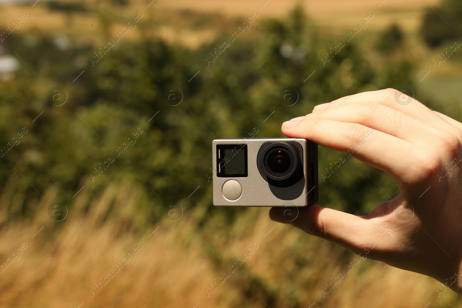 Photo of Man with modern action camera outdoors, closeup. Space for text