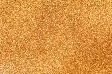 Photo of Shiny golden glitter as background, top view