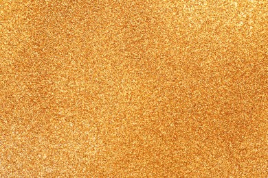 Photo of Shiny golden glitter as background, top view