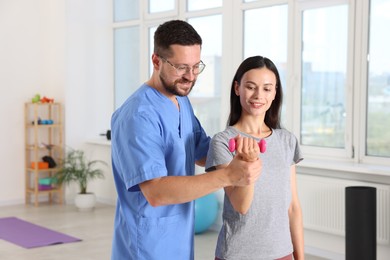 Patient exercising under physiotherapist supervision in rehabilitation center