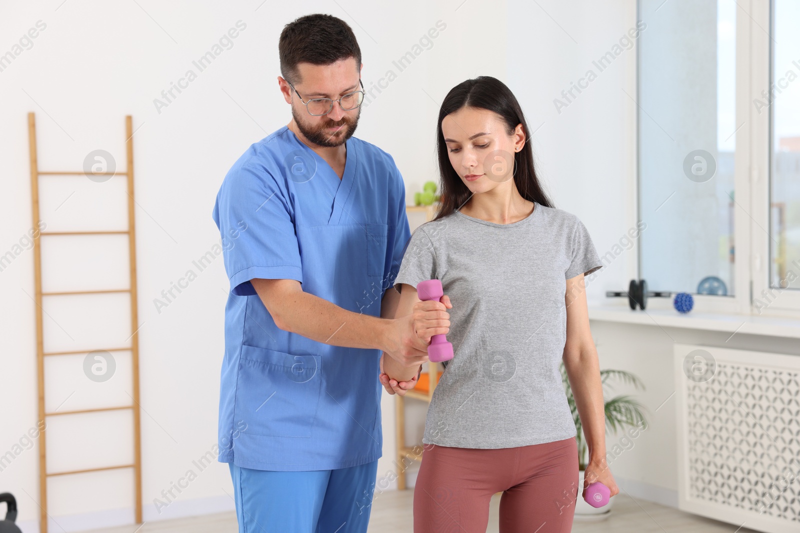 Photo of Patient exercising under physiotherapist supervision in rehabilitation center