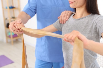 Photo of Physiotherapist working with patient in rehabilitation center, closeup