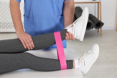 Photo of Physiotherapist working with patient in rehabilitation center, closeup