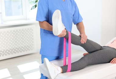 Photo of Physiotherapist working with patient in rehabilitation center, closeup