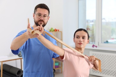 Physiotherapist working with patient in rehabilitation center