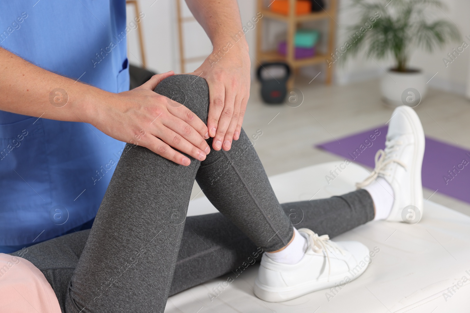 Photo of Physiotherapist working with patient in rehabilitation center, closeup