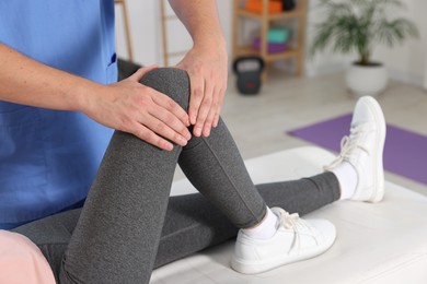 Photo of Physiotherapist working with patient in rehabilitation center, closeup