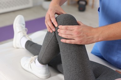 Photo of Physiotherapist working with patient in rehabilitation center, closeup