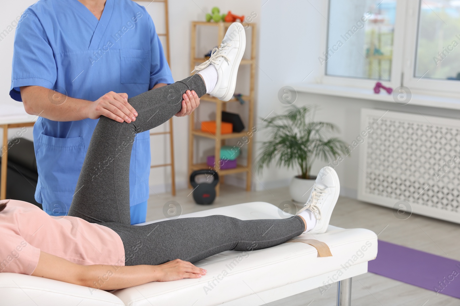 Photo of Physiotherapist working with patient in rehabilitation center, closeup