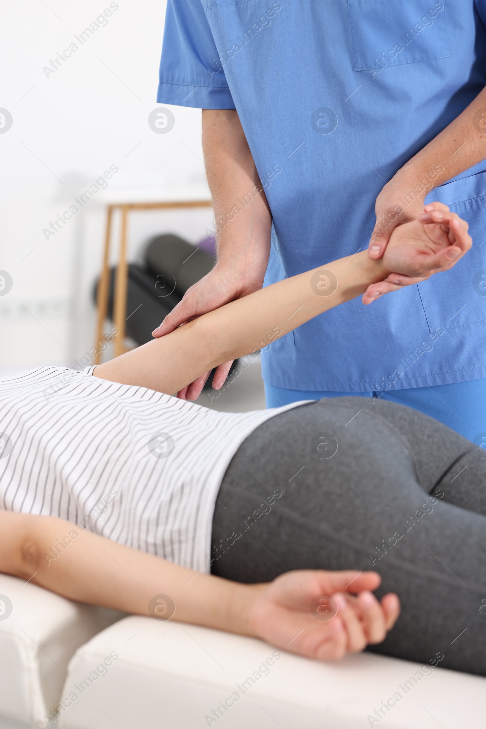 Photo of Physiotherapist working with patient in rehabilitation center, closeup