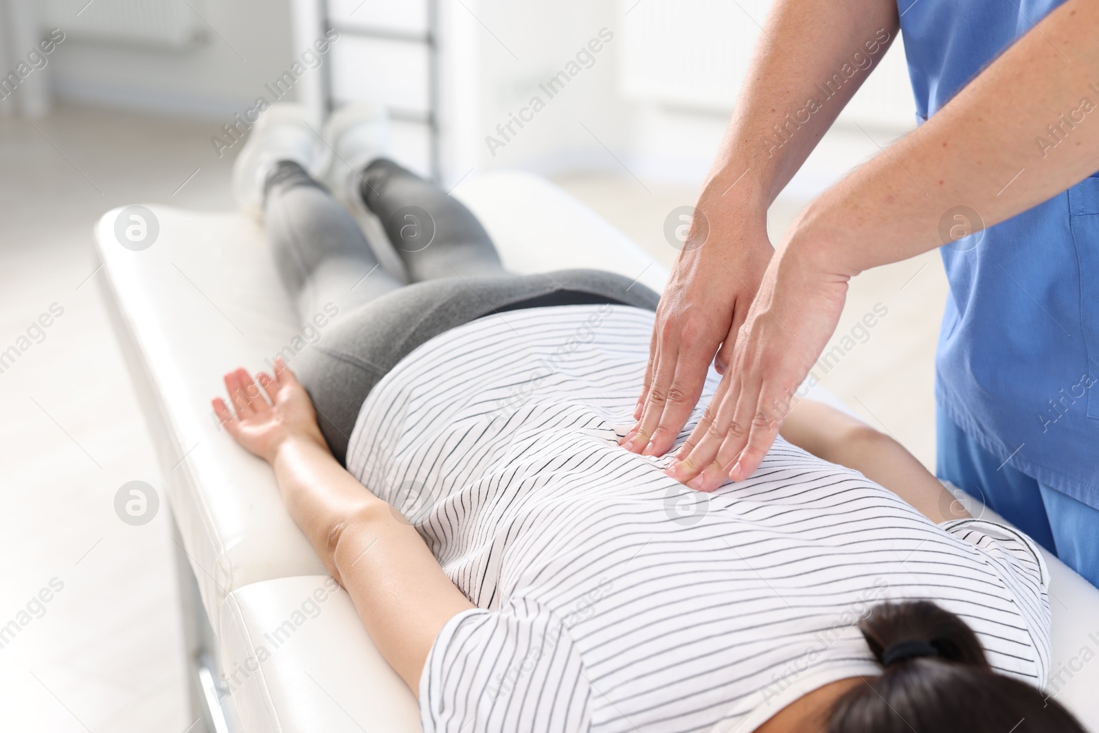 Photo of Physiotherapist working with patient in rehabilitation center, closeup