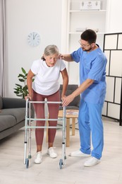 Rehabilitation. Physiotherapist working with senior patient indoors