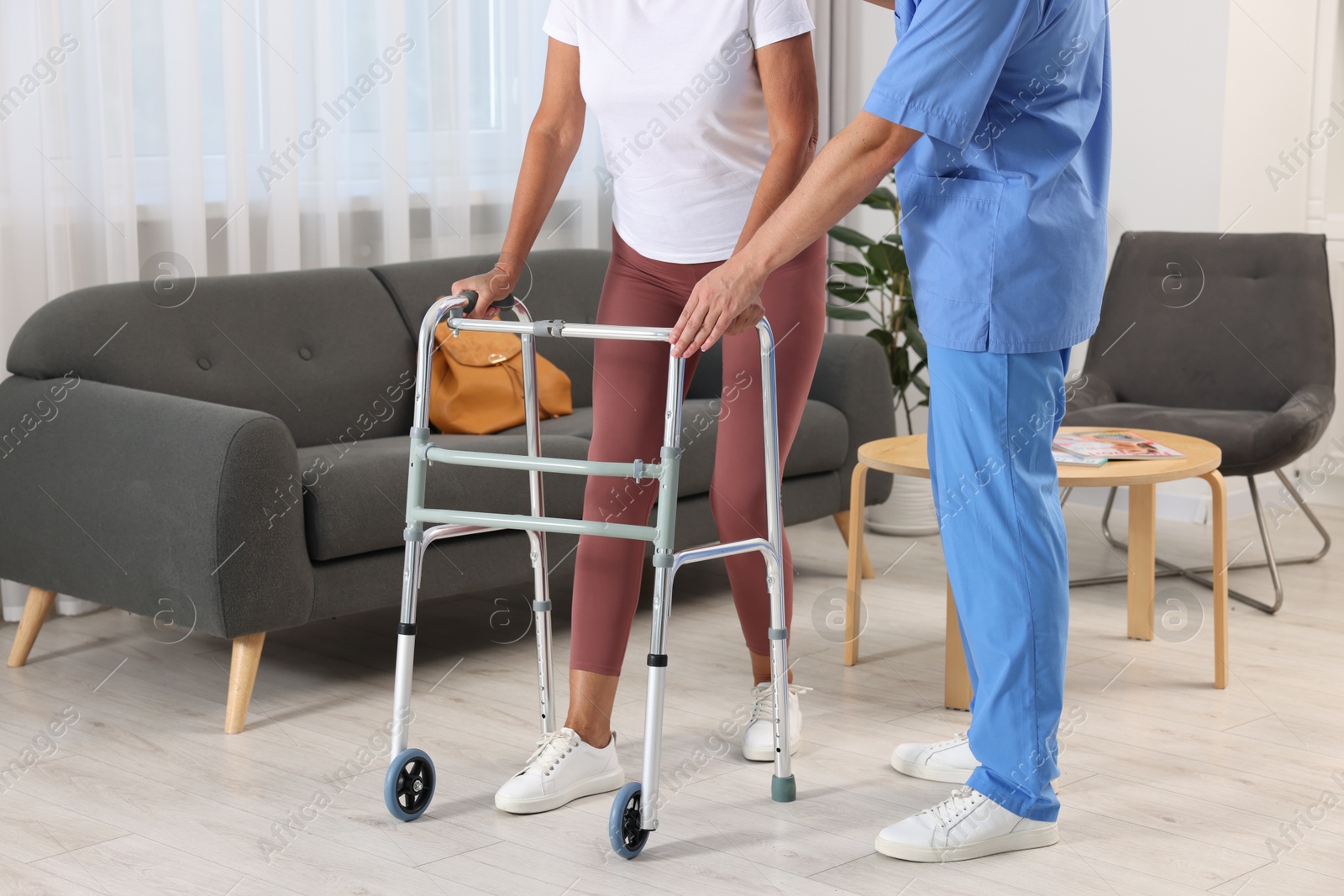 Photo of Rehabilitation. Physiotherapist working with senior patient indoors, closeup