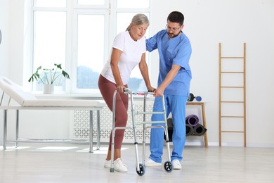 Photo of Physiotherapist working with senior patient in rehabilitation center