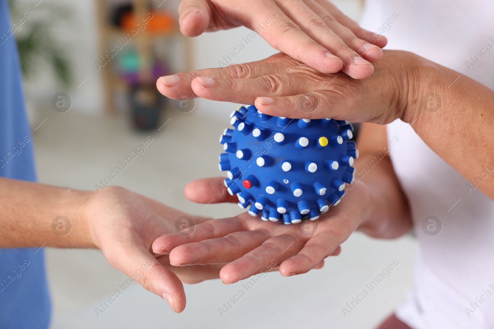 Photo of Physiotherapist working with senior patient in rehabilitation center, closeup