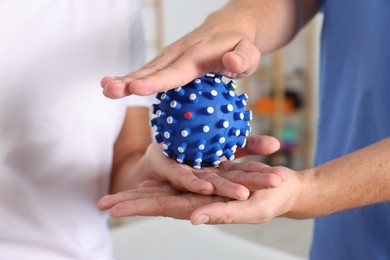 Photo of Physiotherapist working with senior patient in rehabilitation center, closeup