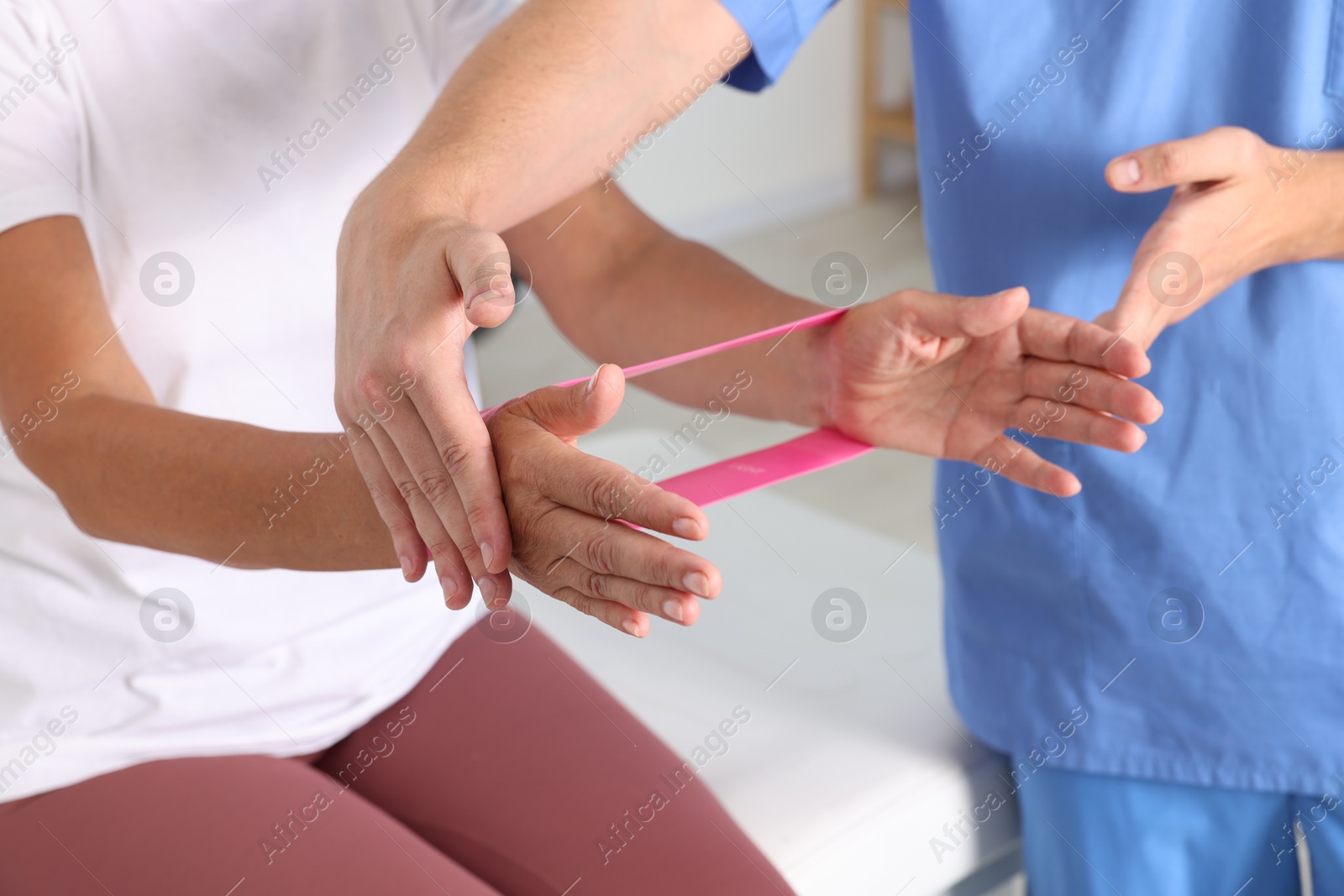 Photo of Senior patient exercising under physiotherapist supervision in rehabilitation center, closeup