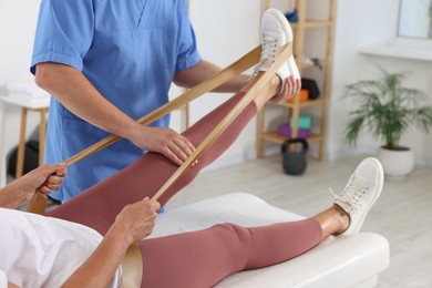 Photo of Physiotherapist working with senior patient in rehabilitation center, closeup