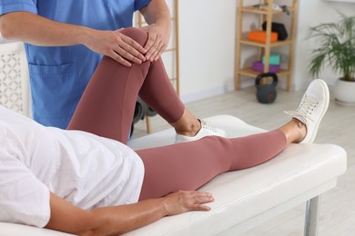 Physiotherapist working with senior patient in rehabilitation center, closeup