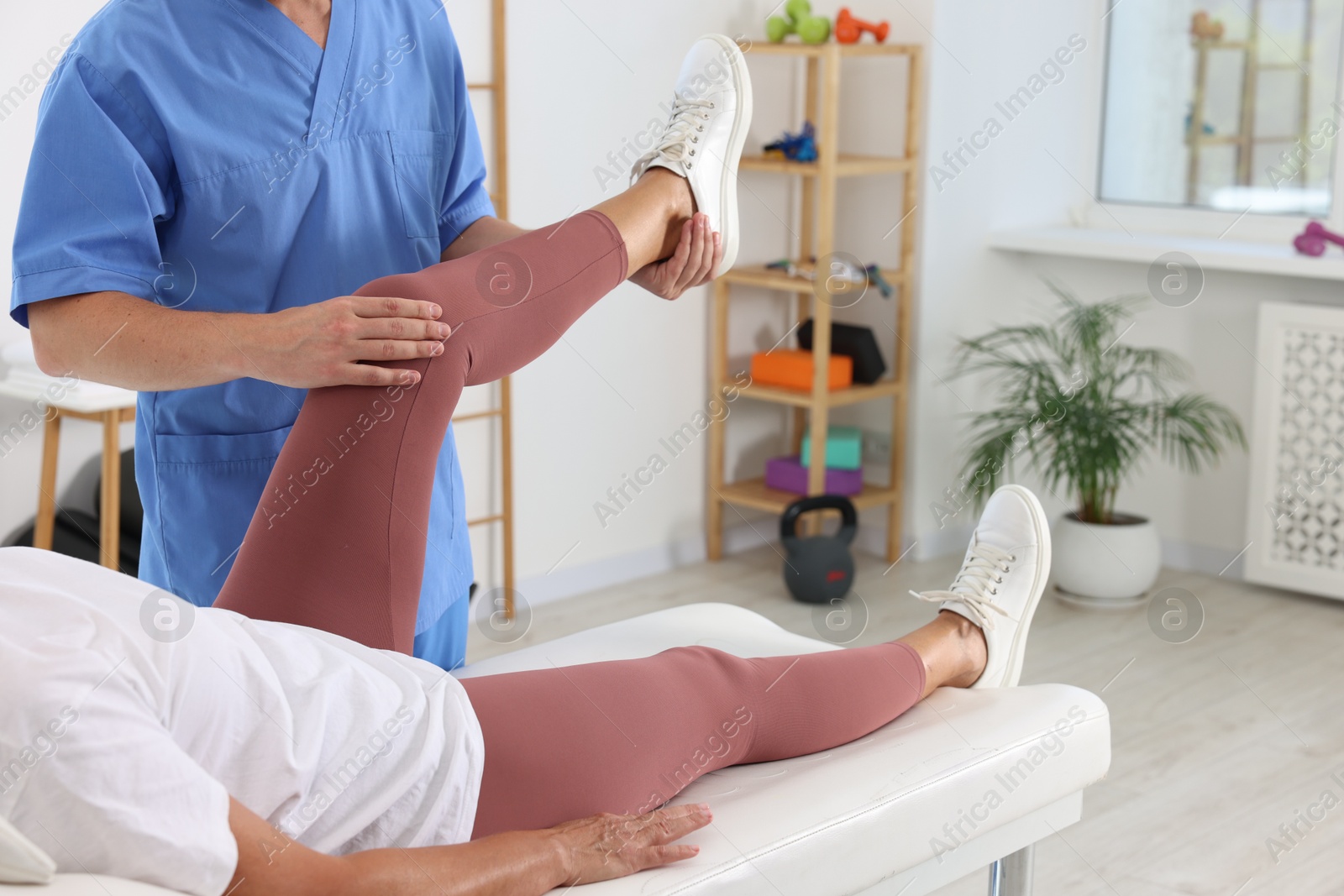 Photo of Physiotherapist working with senior patient in rehabilitation center, closeup