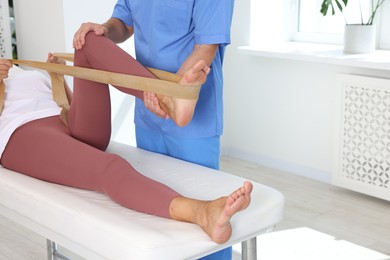 Photo of Physiotherapist working with senior patient in rehabilitation center, closeup