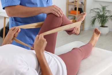 Photo of Physiotherapist working with senior patient in rehabilitation center, closeup