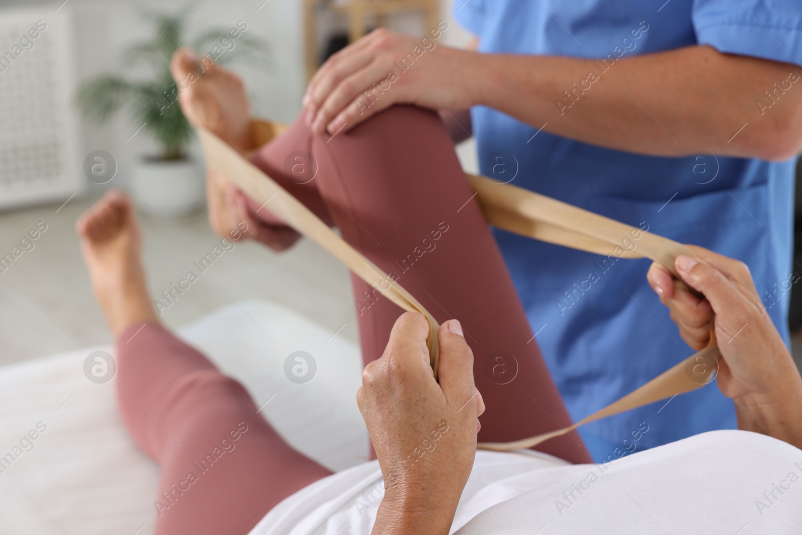 Photo of Physiotherapist working with senior patient in rehabilitation center, closeup